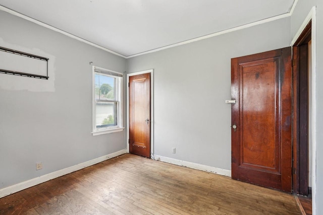 4182 N 13th St, Milwaukee, WI 53209 - unfurnished bedroom featuring baseboards, hardwood / wood-style floors, and ornamental molding