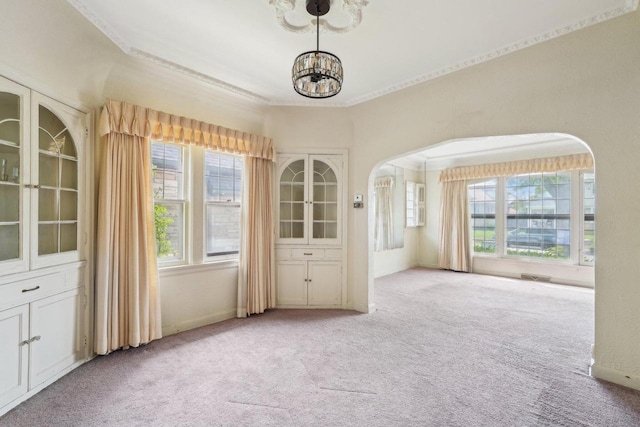 4182 N 13th St, Milwaukee, WI 53209 - carpeted spare room with a chandelier, healthy amount of natural light, ornamental molding, and arched walkways