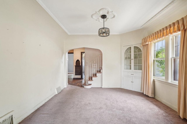 4182 N 13th St, Milwaukee, WI 53209 - empty room featuring arched walkways, carpet floors, ornamental molding, baseboards, and stairs