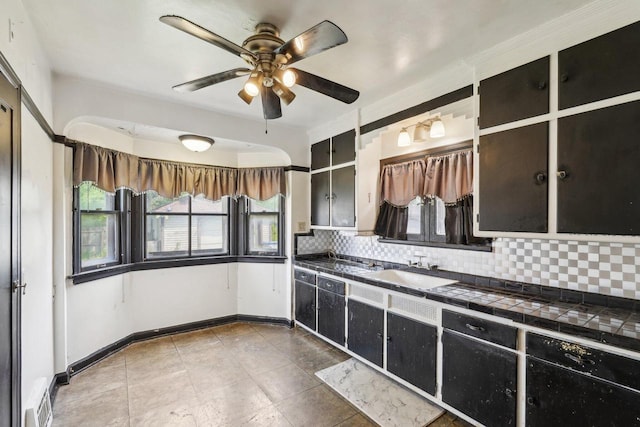 4182 N 13th St, Milwaukee, WI 53209 - kitchen featuring tile counters, backsplash, a sink, ceiling fan, and baseboards