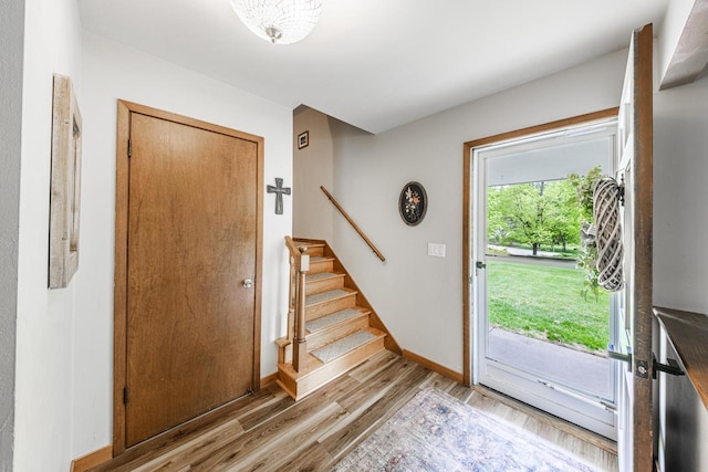 12105 W Shawnee Pass, Mequon, WI 53097 - foyer featuring wood finished floors, stairs, and baseboards