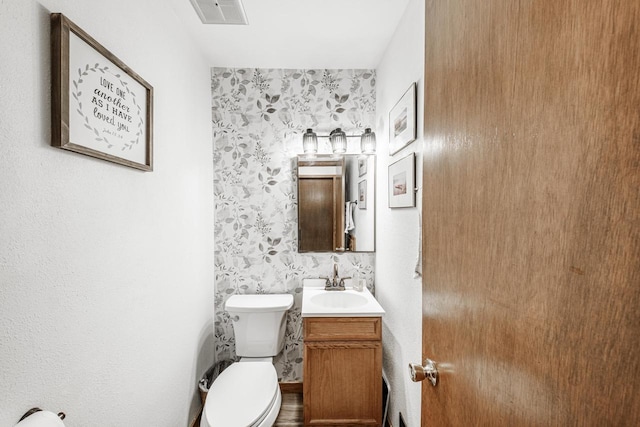 12105 W Shawnee Pass, Mequon, WI 53097 - bathroom featuring vanity, toilet, and wallpapered walls