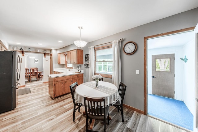 12105 W Shawnee Pass, Mequon, WI 53097 - dining area with light wood-style floors, plenty of natural light, baseboards, and recessed lighting