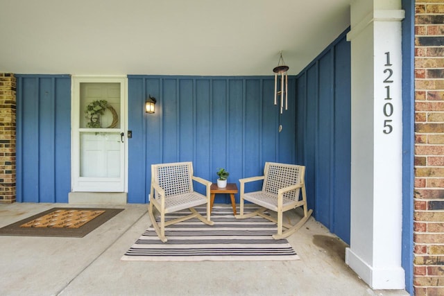 12105 W Shawnee Pass, Mequon, WI 53097 - entrance to property with board and batten siding, brick siding, and a porch