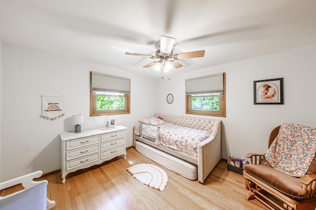 12105 W Shawnee Pass, Mequon, WI 53097 - bedroom with multiple windows, light wood-style floors, ceiling fan, and baseboards