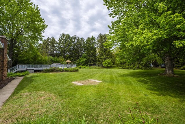 12105 W Shawnee Pass, Mequon, WI 53097 - view of green lawn with a deck