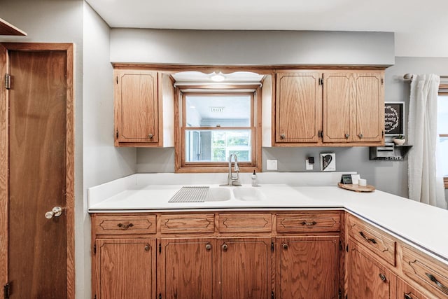 12105 W Shawnee Pass, Mequon, WI 53097 - kitchen featuring a sink and light countertops