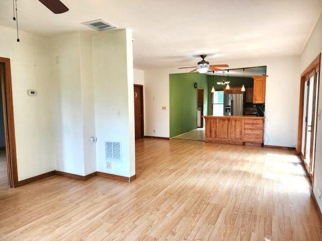 1561 240th Ave, Luck, WI 54853 - unfurnished living room with a ceiling fan, light wood finished floors, and baseboards