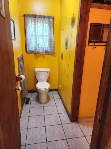 1561 240th Ave, Luck, WI 54853 - bathroom featuring toilet, tile patterned flooring, and baseboards