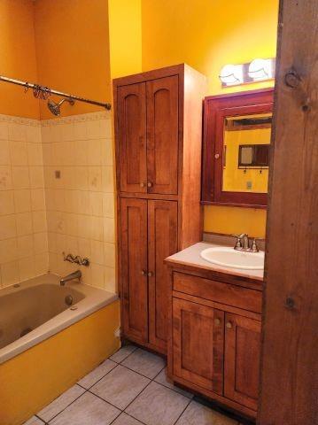 1561 240th Ave, Luck, WI 54853 - full bathroom featuring tile patterned floors, vanity, and shower / bath combination