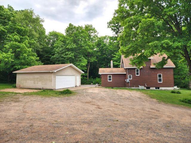 1561 240th Ave, Luck, WI 54853 - view of property exterior with a detached garage and an outbuilding