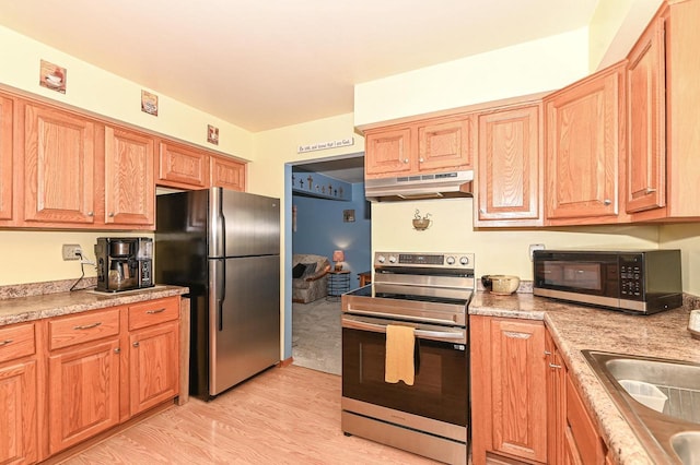 7538 S 74th St, Franklin, WI 53132 - kitchen with stainless steel appliances, under cabinet range hood, light wood finished floors, and light countertops