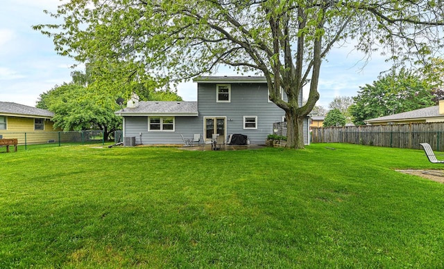 7538 S 74th St, Franklin, WI 53132 - back of property with a chimney, central AC unit, and a patio area