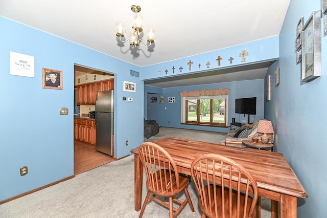 7538 S 74th St, Franklin, WI 53132 - dining area featuring a chandelier, light carpet, and baseboards