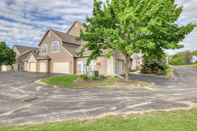 W159N4872 Graysland Dr, Menomonee Falls, WI 53051 - view of front of home featuring driveway, a shingled roof, and cooling unit