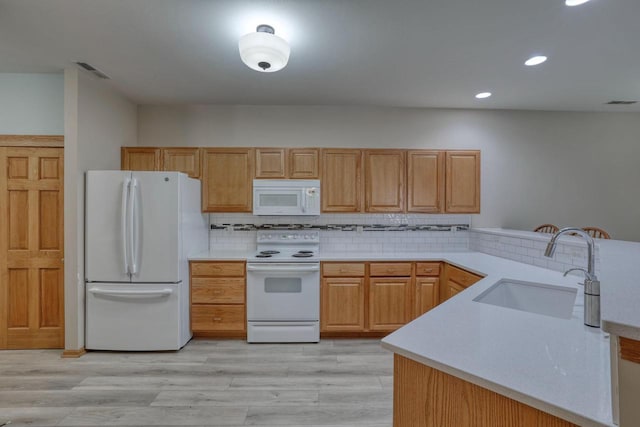 W159N4872 Graysland Dr, Menomonee Falls, WI 53051 - kitchen with white appliances, a sink, recessed lighting, light countertops, and tasteful backsplash
