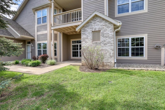 W159N4872 Graysland Dr, Menomonee Falls, WI 53051 - entrance to property with a balcony, a yard, and stone siding