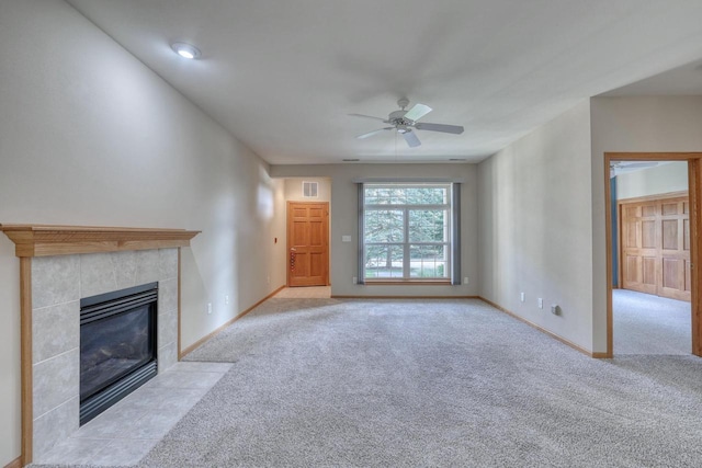 W159N4872 Graysland Dr, Menomonee Falls, WI 53051 - unfurnished living room with carpet, a ceiling fan, a tiled fireplace, and baseboards