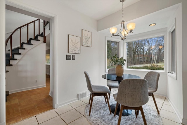4696 N Lake Dr, Whitefish Bay, WI 53211 - dining area with stairs, a chandelier, and baseboards