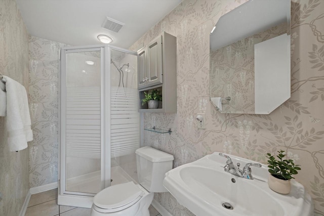 4696 N Lake Dr, Whitefish Bay, WI 53211 - bathroom with toilet, a shower stall, tile patterned flooring, wallpapered walls, and a sink