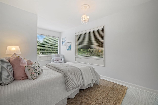 4696 N Lake Dr, Whitefish Bay, WI 53211 - carpeted bedroom with a chandelier and baseboards
