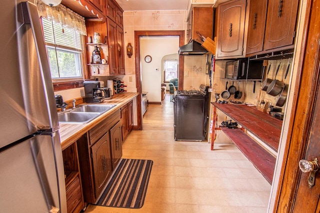 917 Whitewater Ave, Fort Atkinson, WI 53538 - kitchen with freestanding refrigerator, gas range oven, a sink, light flooring, and light countertops