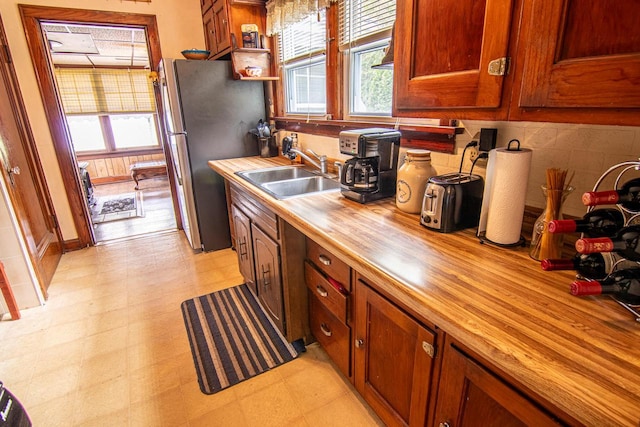 917 Whitewater Ave, Fort Atkinson, WI 53538 - kitchen with wood counters, a sink, healthy amount of natural light, and freestanding refrigerator