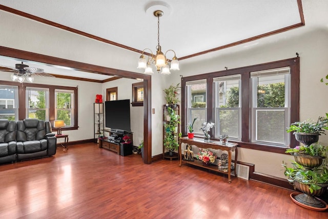 2049 S 77th St, West Allis, WI 53219 - living room featuring wood finished floors, baseboards, ornamental molding, a chandelier, and a ceiling fan