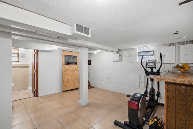 2049 S 77th St, West Allis, WI 53219 - workout room with electric panel, a textured ceiling, light tile patterned floors, and baseboards