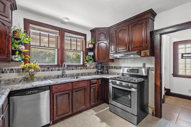 2049 S 77th St, West Allis, WI 53219 - kitchen featuring stainless steel appliances, a sink, under cabinet range hood, and decorative backsplash