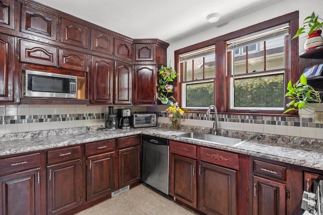 2049 S 77th St, West Allis, WI 53219 - kitchen with stainless steel appliances, a sink, decorative backsplash, and healthy amount of natural light