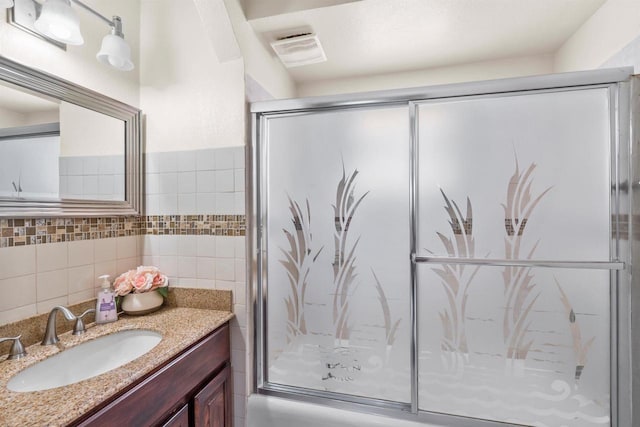 2049 S 77th St, West Allis, WI 53219 - bathroom featuring vanity, a shower stall, and tile walls