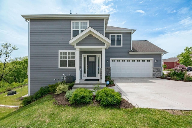 529 Century Oak Dr, Waukesha, WI 53188 - view of front of home with driveway, central AC unit, a front yard, a garage, and stone siding