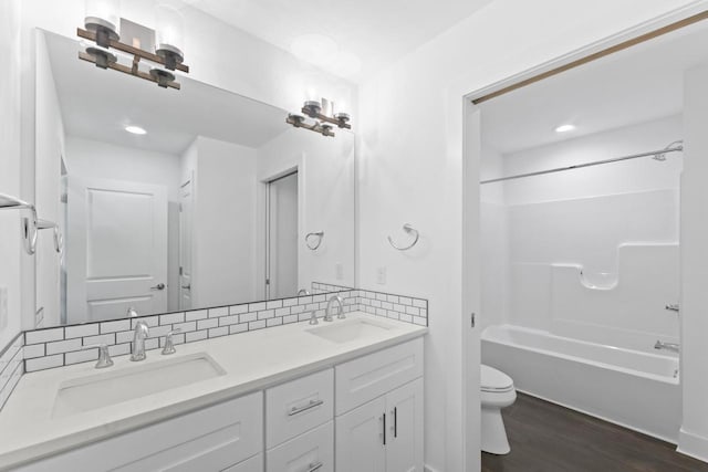 529 Century Oak Dr, Waukesha, WI 53188 - bathroom with toilet, double vanity, wood finished floors, tub / shower combination, and recessed lighting