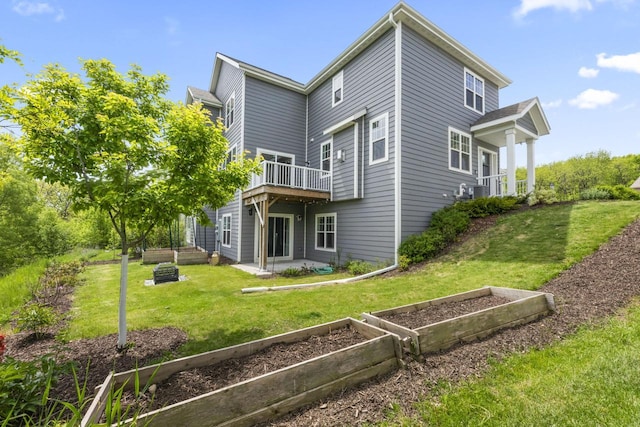 529 Century Oak Dr, Waukesha, WI 53188 - rear view of house with a garden, a lawn, a wooden deck, and a patio area