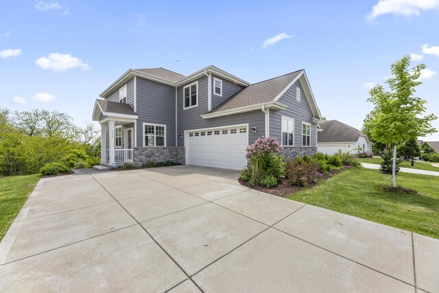 529 Century Oak Dr, Waukesha, WI 53188 - view of front facade with stone siding, a front yard, driveway, and an attached garage