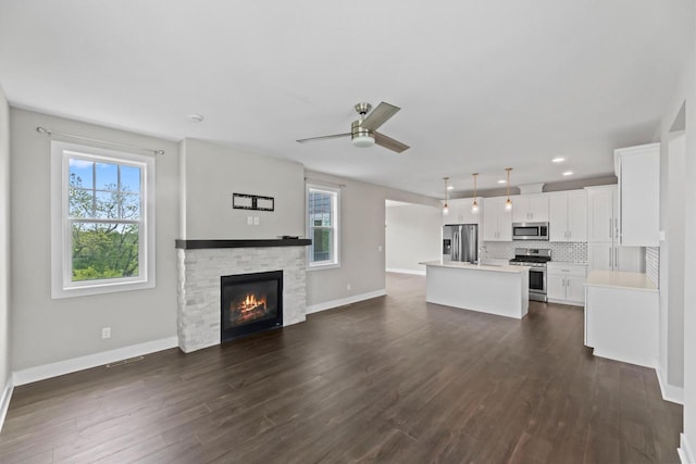 529 Century Oak Dr, Waukesha, WI 53188 - unfurnished living room with plenty of natural light, a ceiling fan, a fireplace, baseboards, and recessed lighting