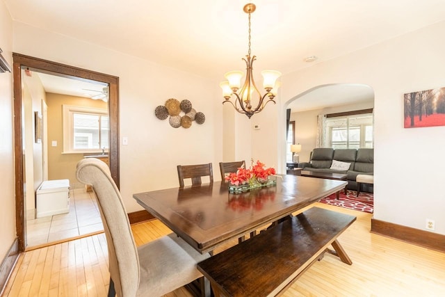 150 S James St, Waukesha, WI 53186 - dining room featuring arched walkways, light wood-style flooring, plenty of natural light, and baseboards