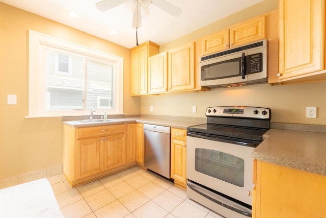 150 S James St, Waukesha, WI 53186 - kitchen with appliances with stainless steel finishes, light brown cabinetry, a sink, ceiling fan, and light tile patterned floors