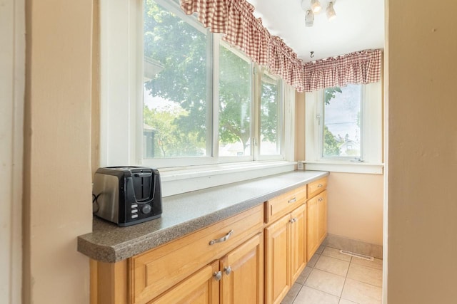 150 S James St, Waukesha, WI 53186 - kitchen with light tile patterned flooring, light brown cabinetry, and baseboards