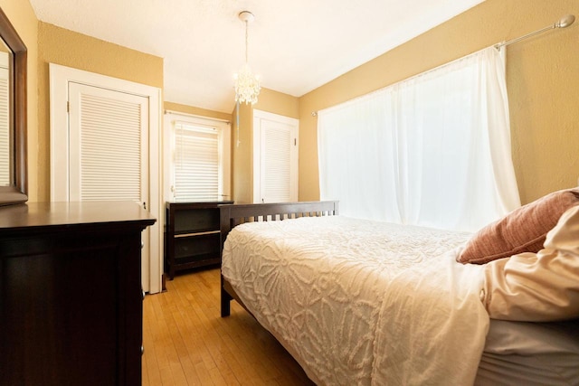 150 S James St, Waukesha, WI 53186 - bedroom with light wood-style flooring and a chandelier