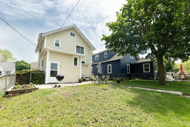 150 S James St, Waukesha, WI 53186 - back of house with a patio and a vegetable garden