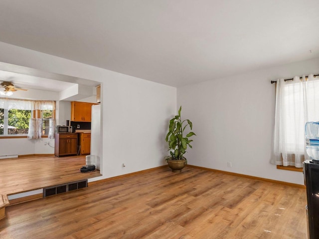 9446 W Lynx Ct, Milwaukee, WI 53225 - unfurnished living room featuring light wood-style floors and baseboards