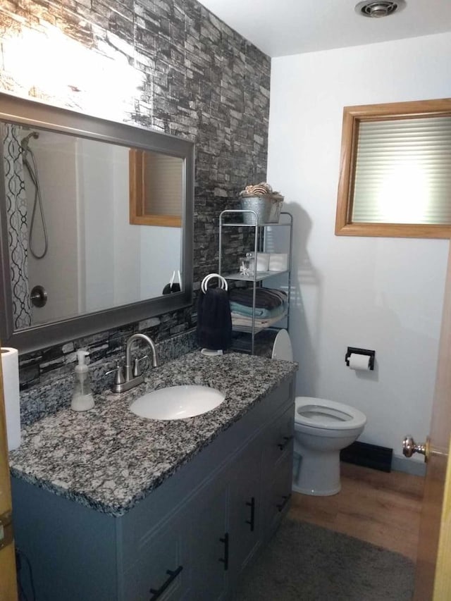 9446 W Lynx Ct, Milwaukee, WI 53225 - bathroom featuring vanity, toilet, wood finished floors, and baseboards