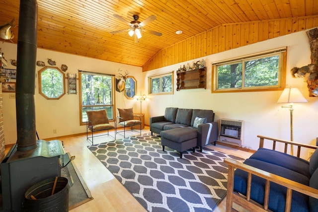 W2761 49th St, Mauston, WI 53948 - living room with a wood stove, lofted ceiling, wood ceiling, heating unit, and wood finished floors