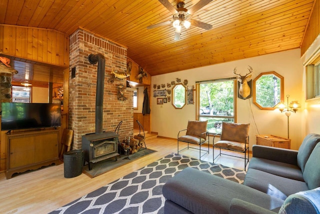 W2761 49th St, Mauston, WI 53948 - living area with a wood stove, vaulted ceiling, ceiling fan, healthy amount of natural light, and wooden ceiling