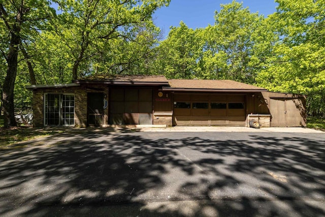 W2761 49th St, Mauston, WI 53948 - view of front facade with a garage and brick siding
