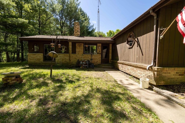 W2761 49th St, Mauston, WI 53948 - ranch-style house featuring brick siding, a chimney, and a front lawn