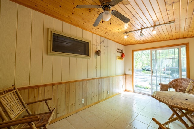 W2761 49th St, Mauston, WI 53948 - sitting room with track lighting, wooden walls, wood ceiling, a ceiling fan, and baseboards