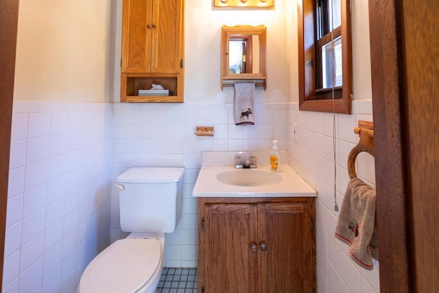W2761 49th St, Mauston, WI 53948 - half bathroom featuring toilet, vanity, tile walls, and wainscoting